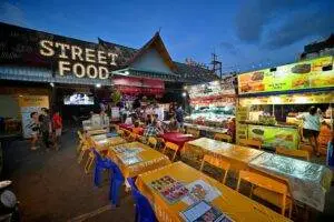Bustling night market with colorful street food stalls in Patong, Phuket, showcasing vibrant Thai culture.