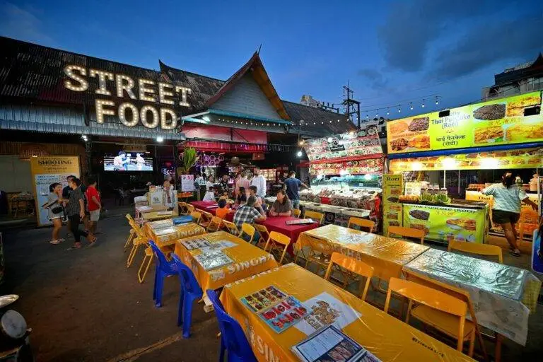 Bustling night market with colorful street food stalls in Patong, Phuket, showcasing vibrant Thai culture.