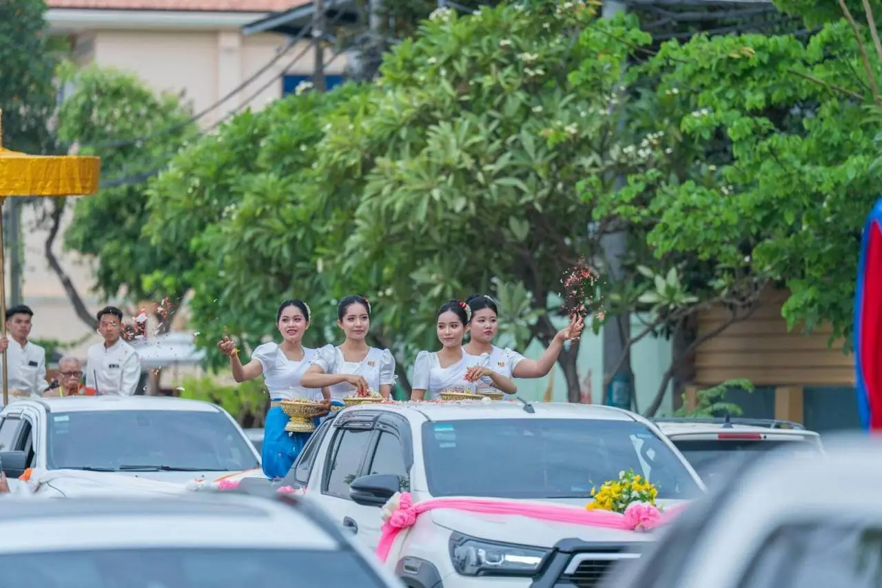 Colorful traditional procession in Battambang, Cambodia, featuring cultural dress and floral decorations.